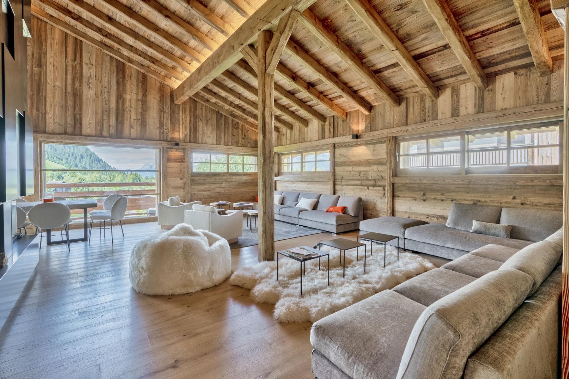Open living area with vaulted timber ceilings and sectional seating for 12