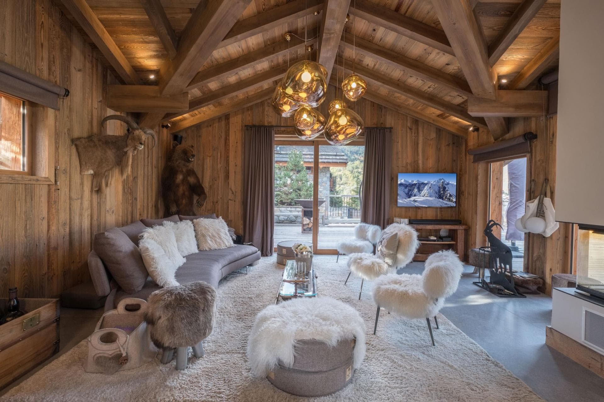 Living area with vaulted timber beams and access to private sun deck