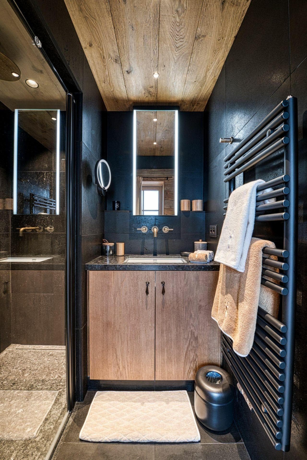 Bathroom vanity with backlit mirror and heated towel rack