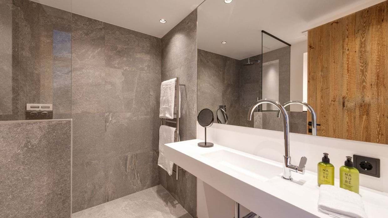 Bathroom with walk-in stone shower and heated towel rail