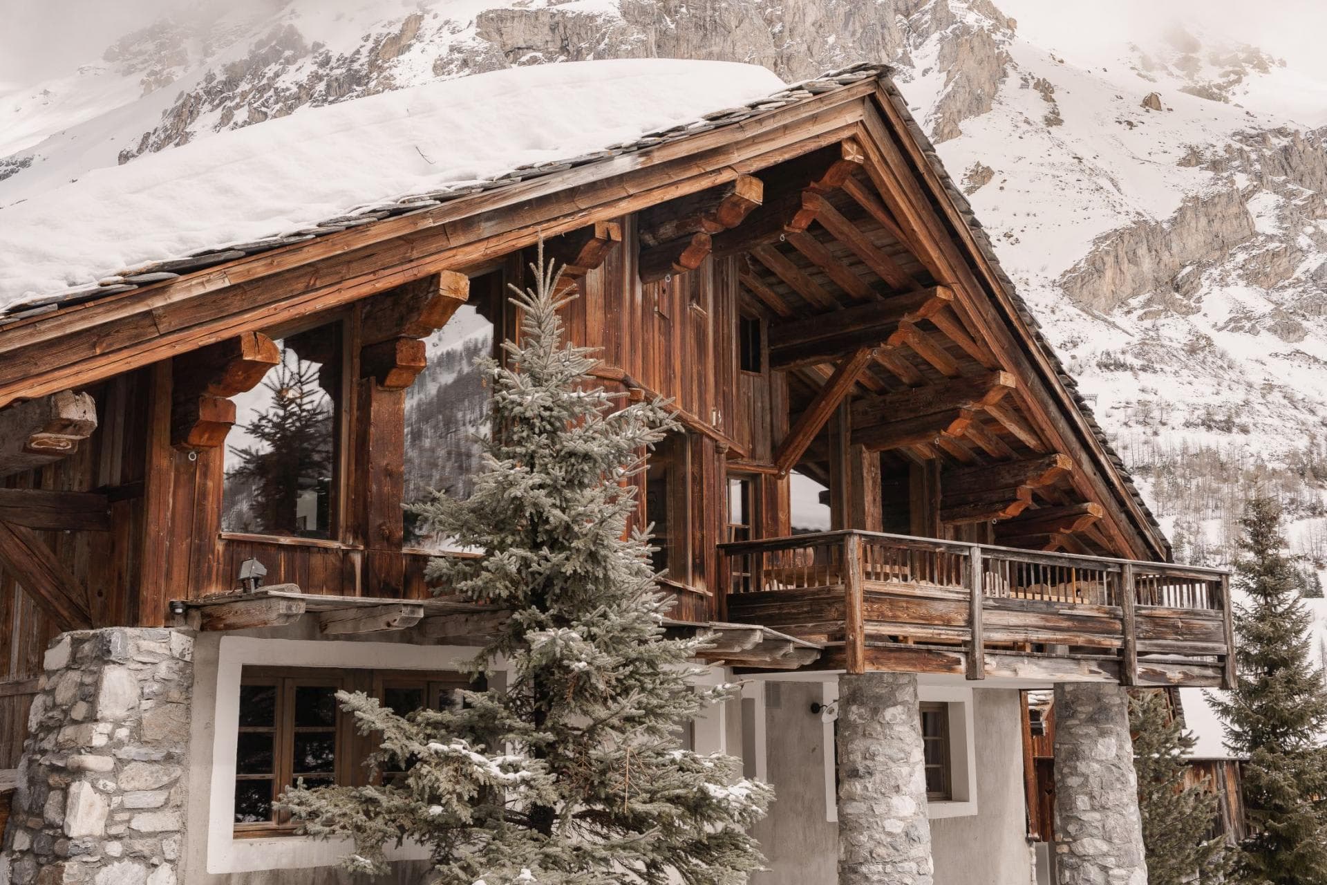Alpine chalet with stone pillars and private timber balcony