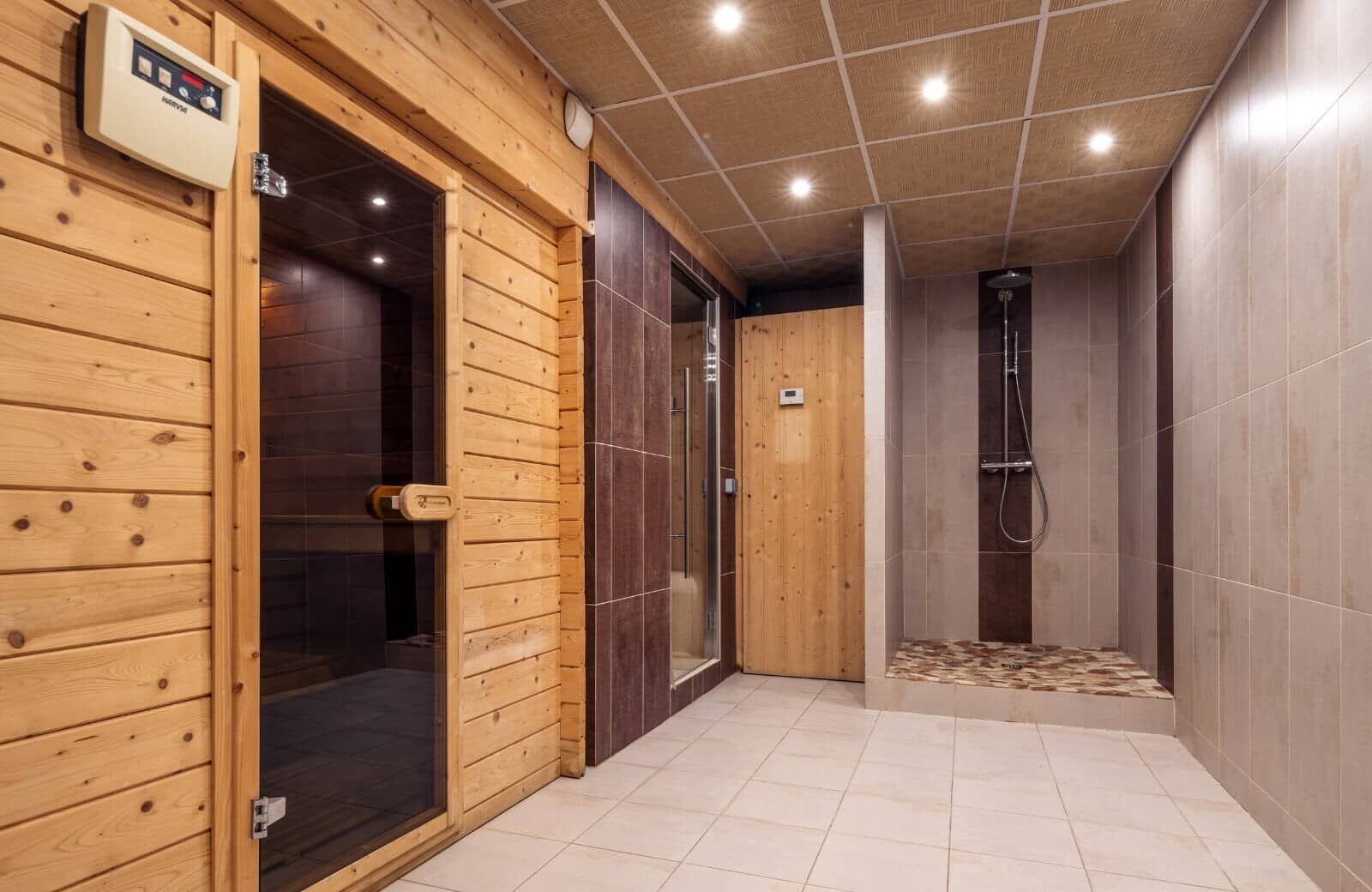 Spa area with Finnish sauna, steam room, and walk-in rain shower