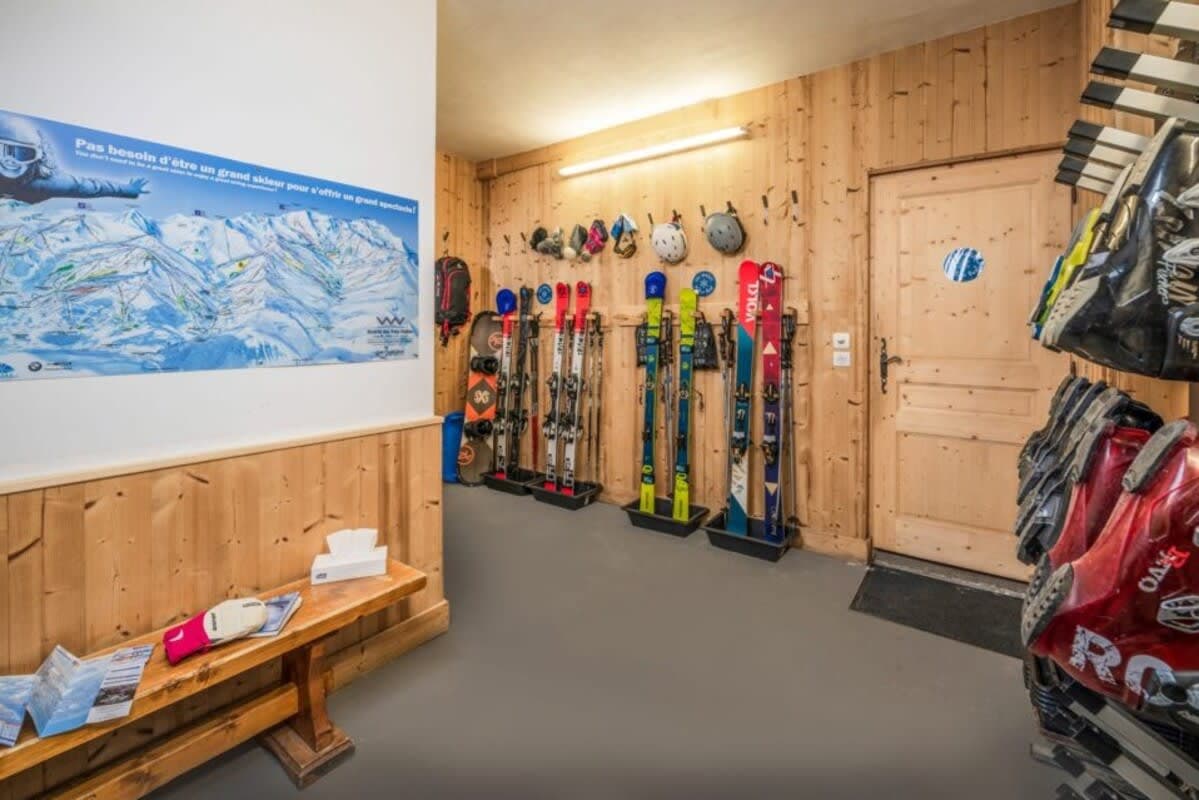 Ski room with gear storage, boot dryers, and local piste map