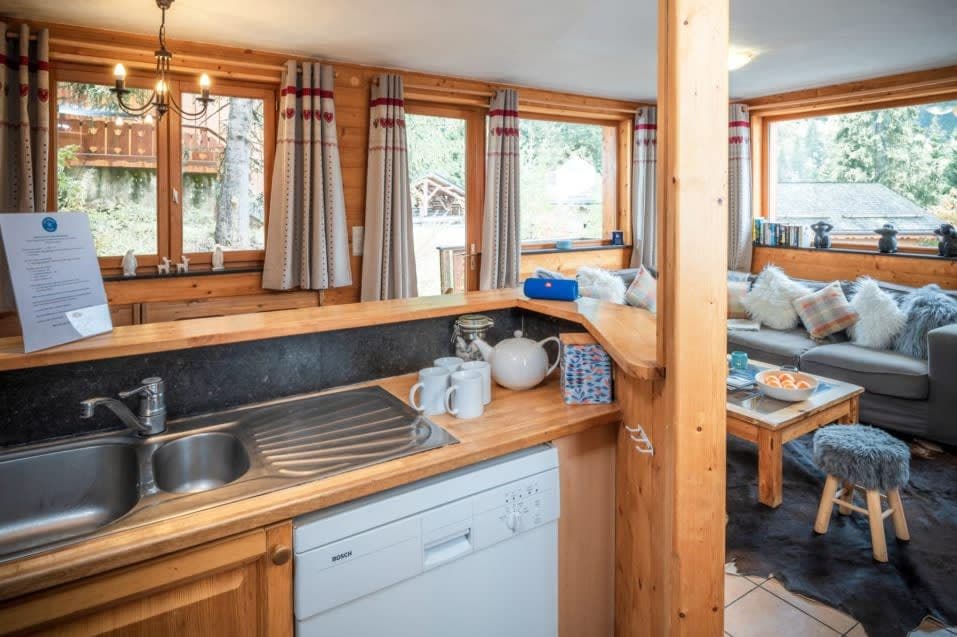 Kitchen overlooking living area with Bosch dishwasher and double sink