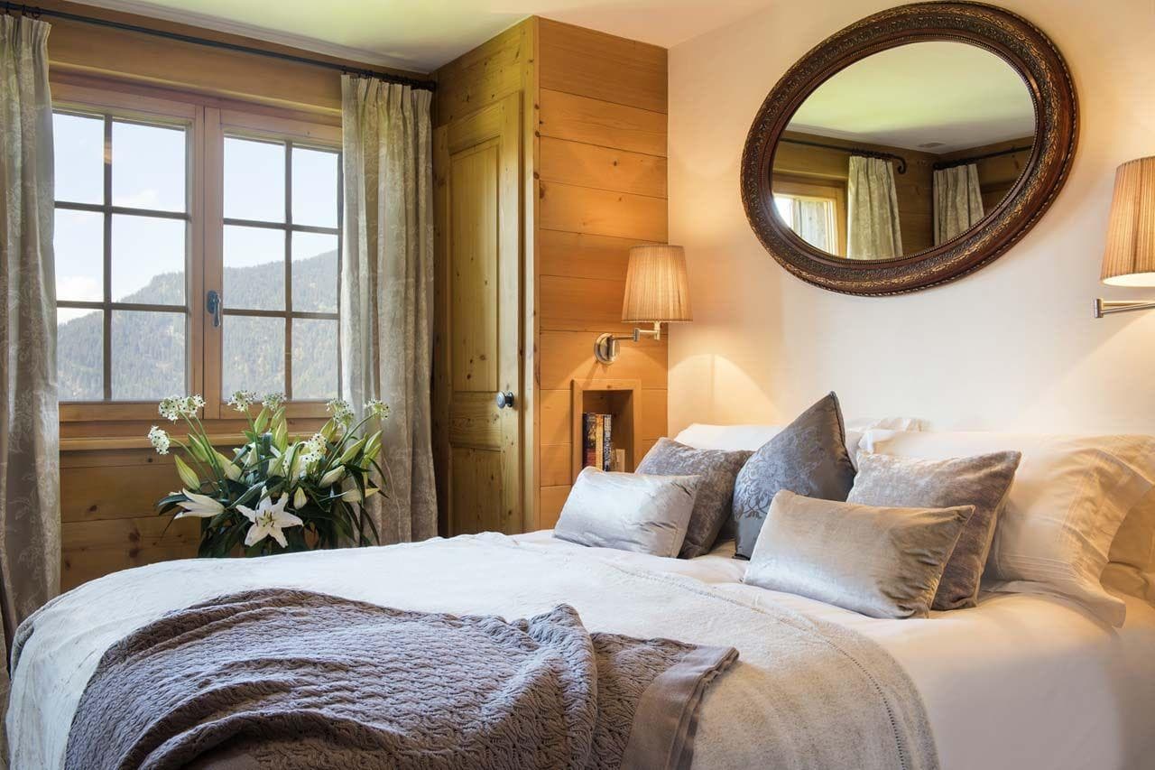 Bedroom with mountain views and bedside reading lamps