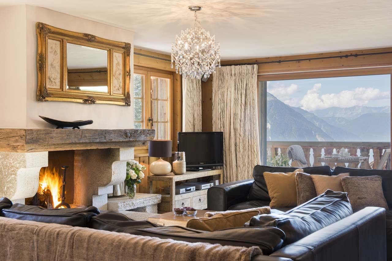 Living room with wood-burning fireplace and mountain-view balcony