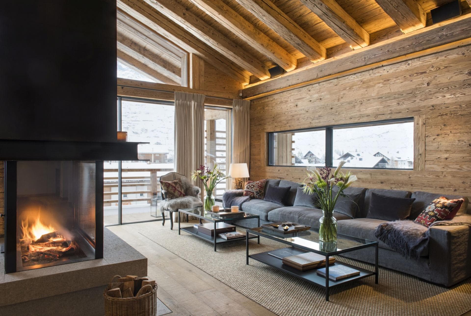 Living area with wood-burning fireplace and mountain-view balcony access