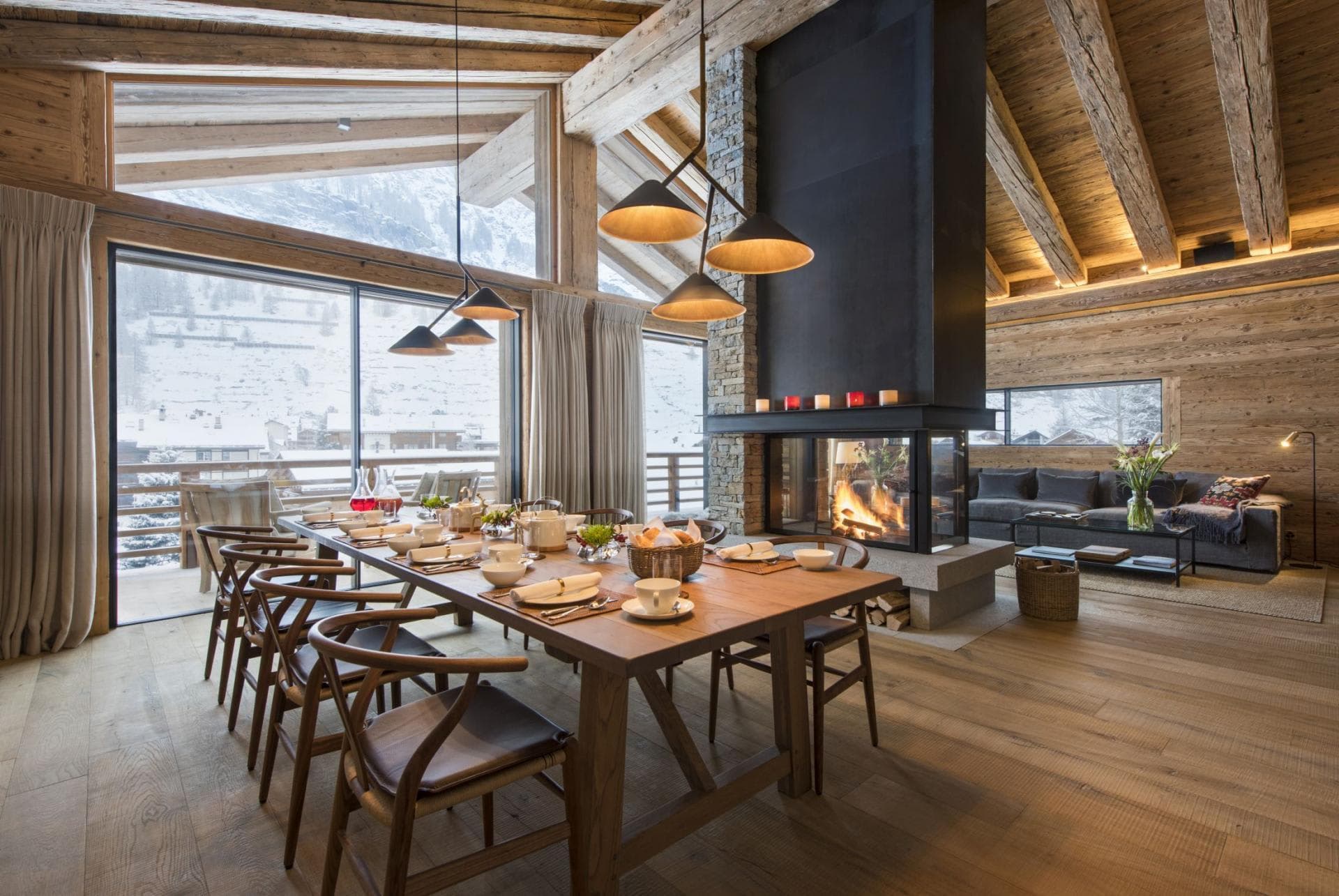 Dining area seats 10 beside double-sided fireplace and mountain-view balcony