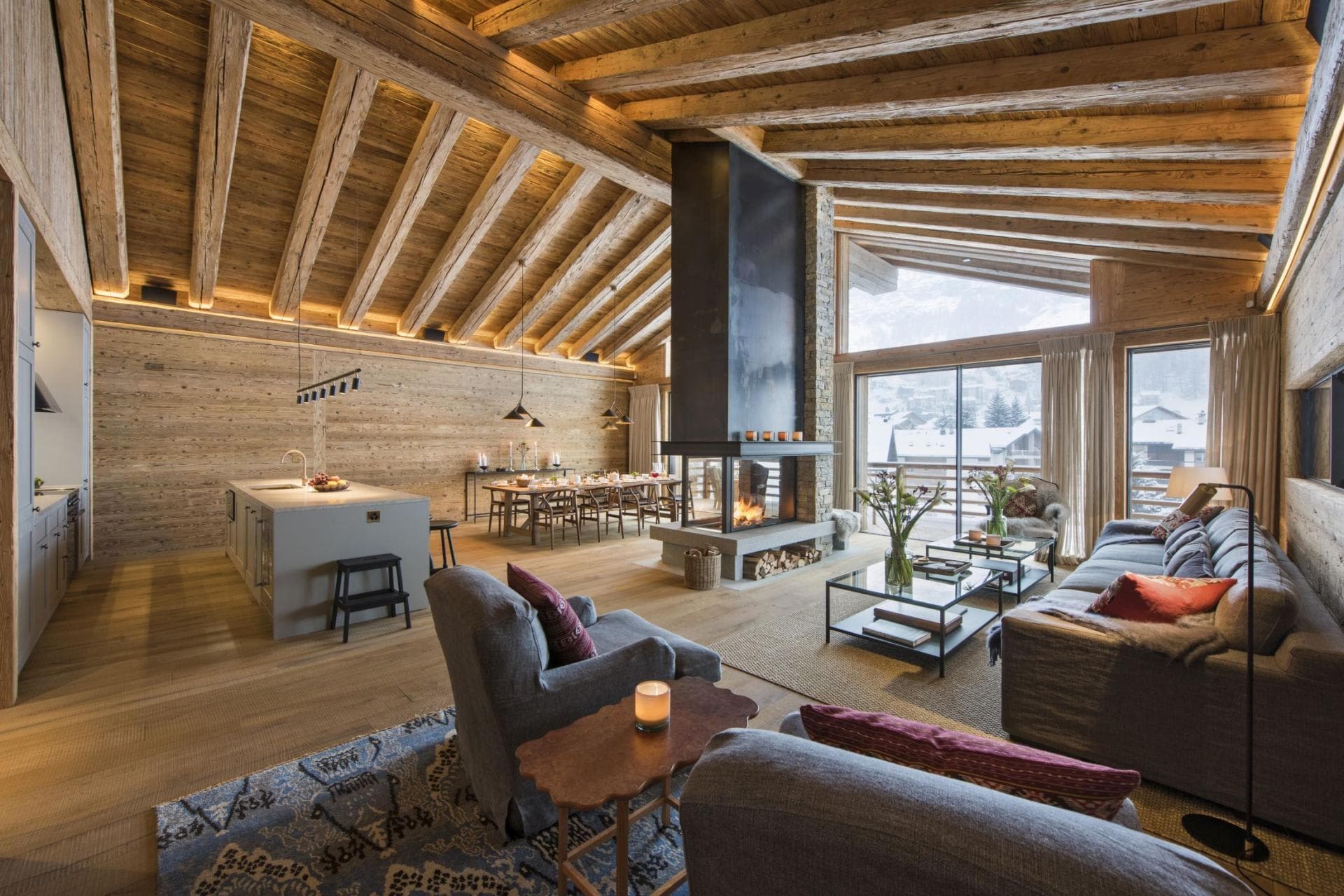 Open-plan living area with wood-burning fireplace and dining seating for 10