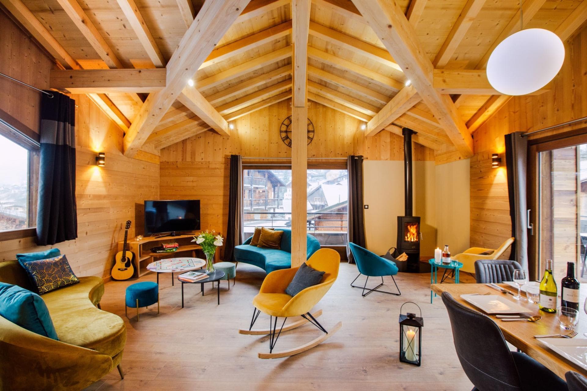 Open-plan living area with wood-burning stove and vaulted timber ceilings