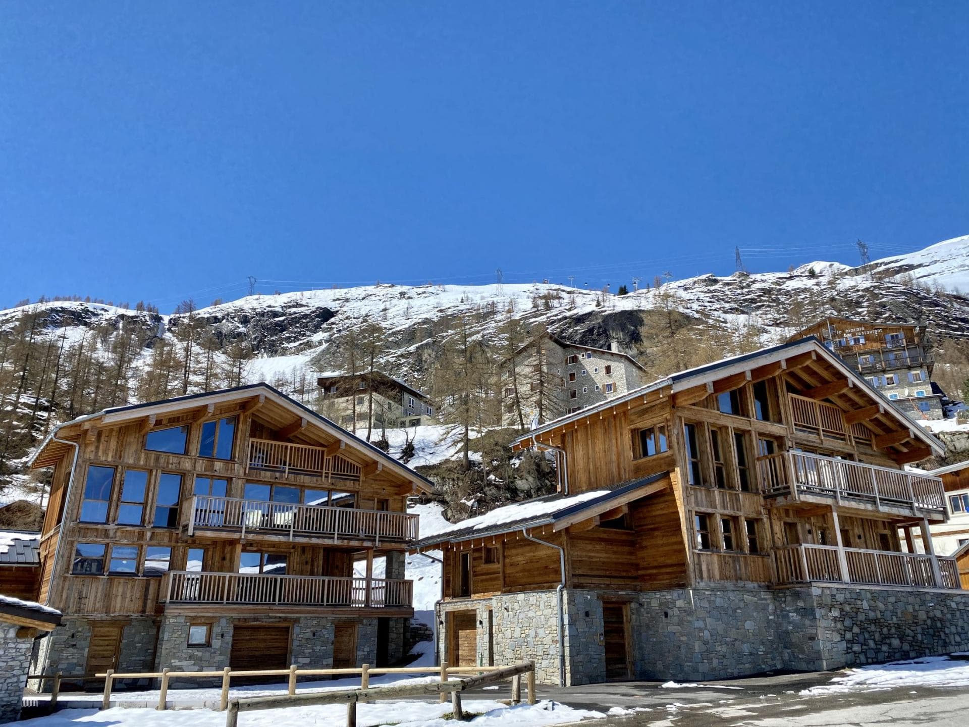 Ski-in/ski-out timber chalets with private balconies and mountain views