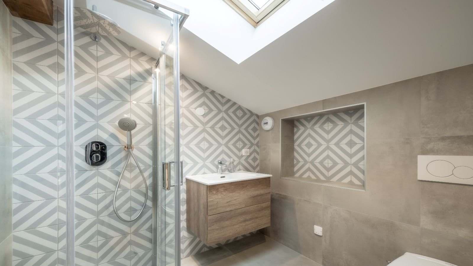 Bathroom with walk-in shower and natural light from skylight