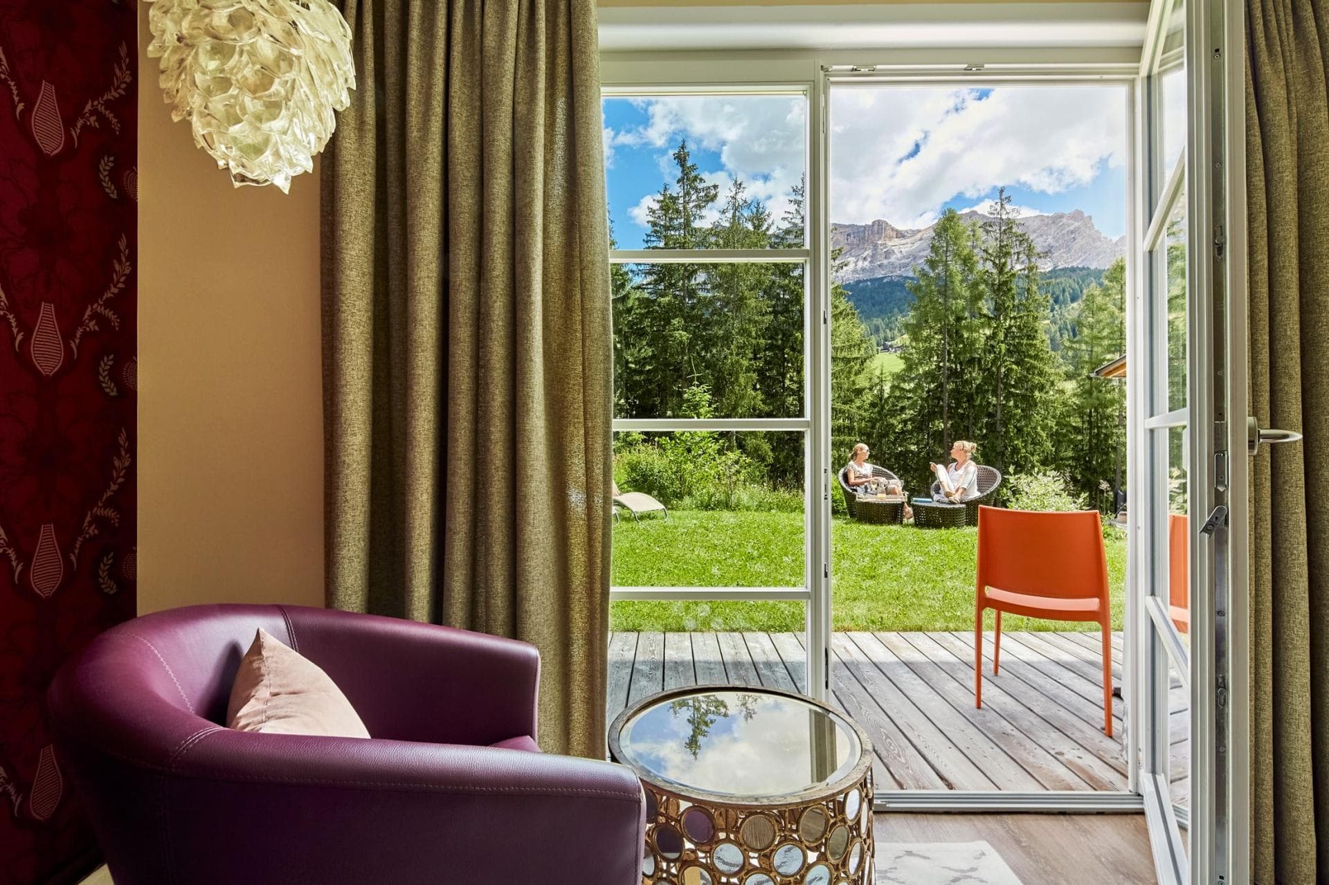 Sitting area with glass doors opening to private deck and mountain views