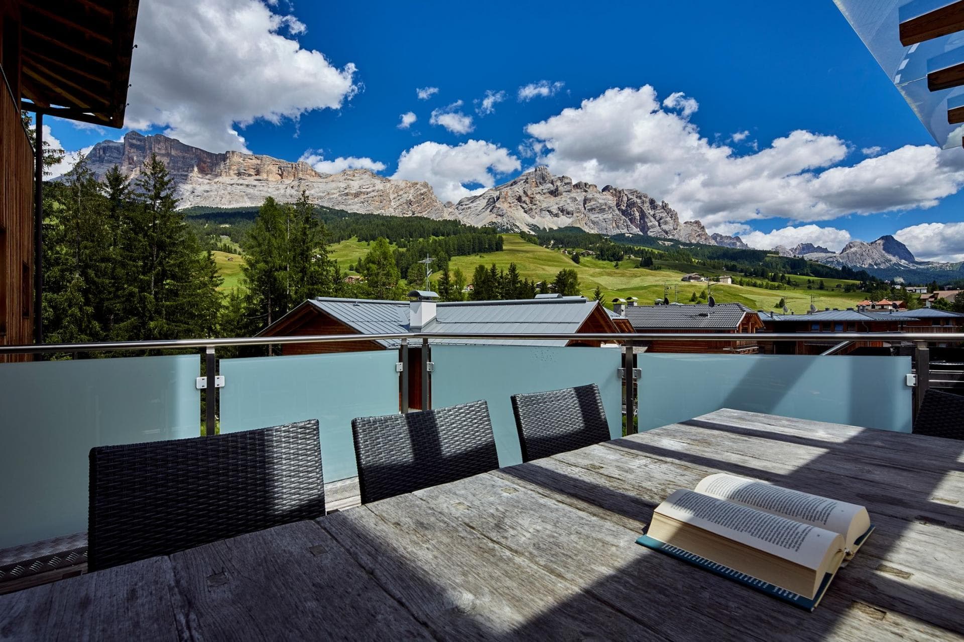 Outdoor terrace with dining table and views of the Dolomite peaks