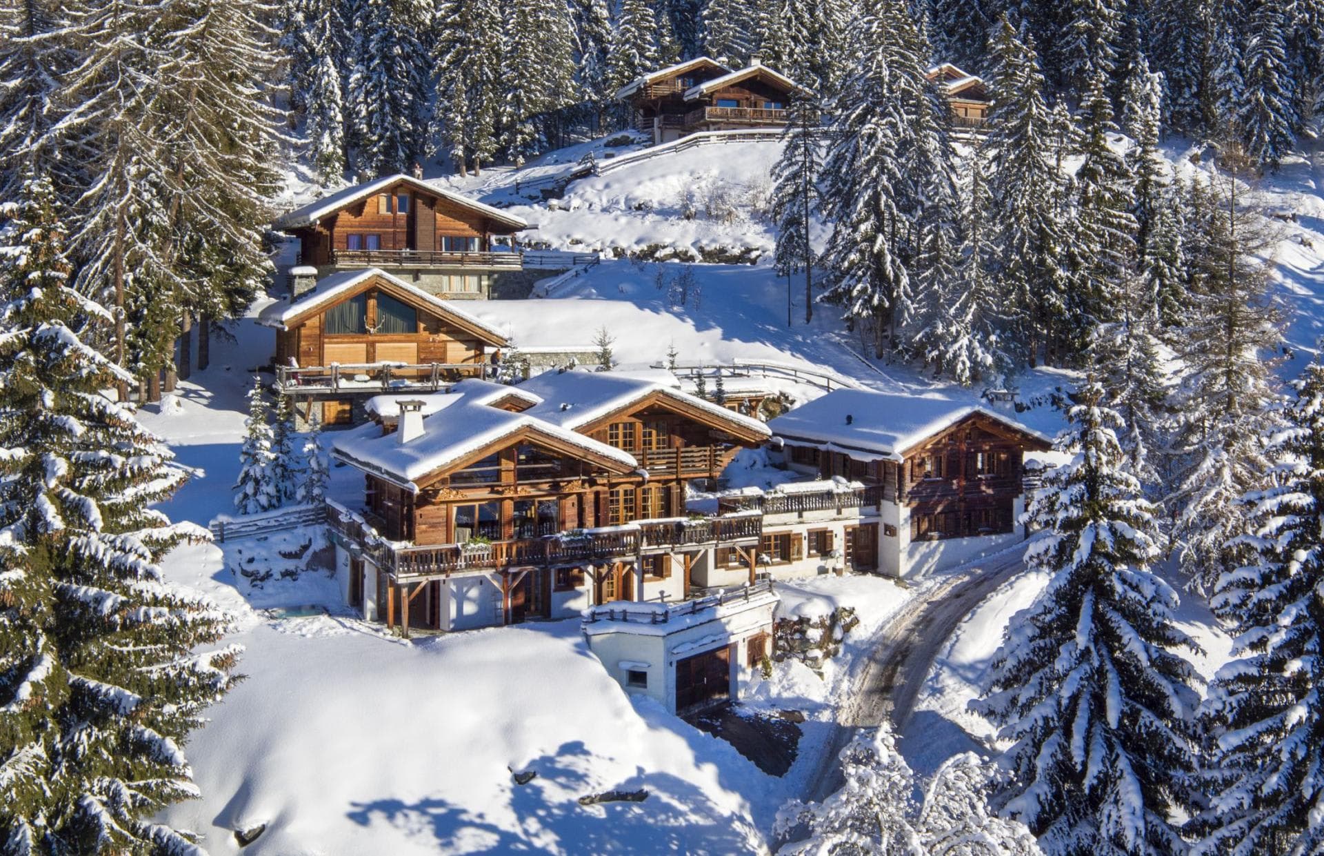 Traditional timber chalet with tiered balconies and snowy forest views