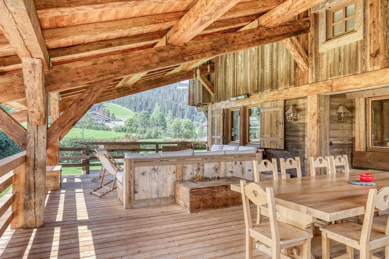 Covered timber deck with lounge seating and 8-person dining table