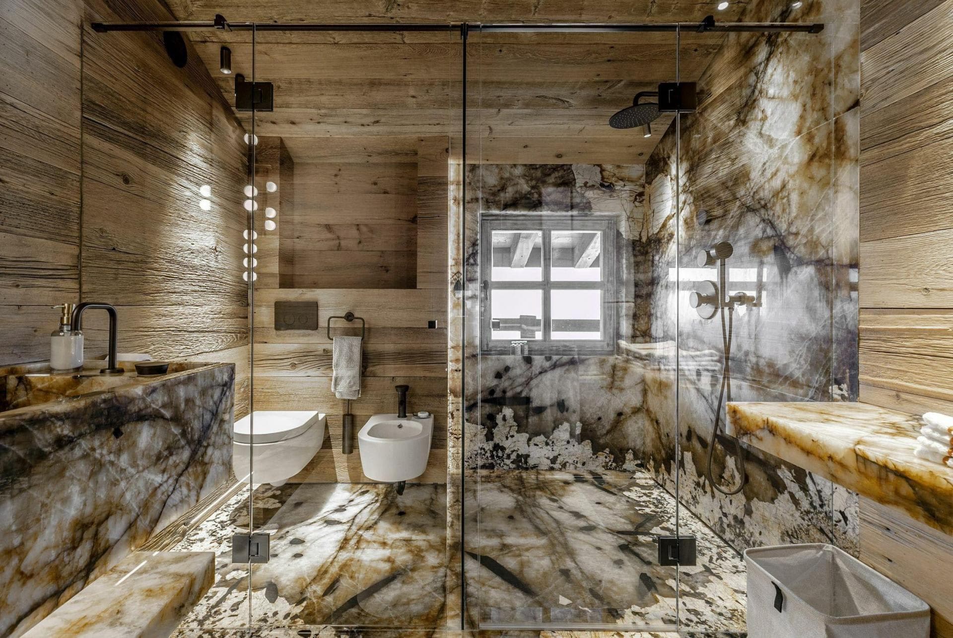 Bathroom with walk-in rain shower, bidet, and marble-clad walls