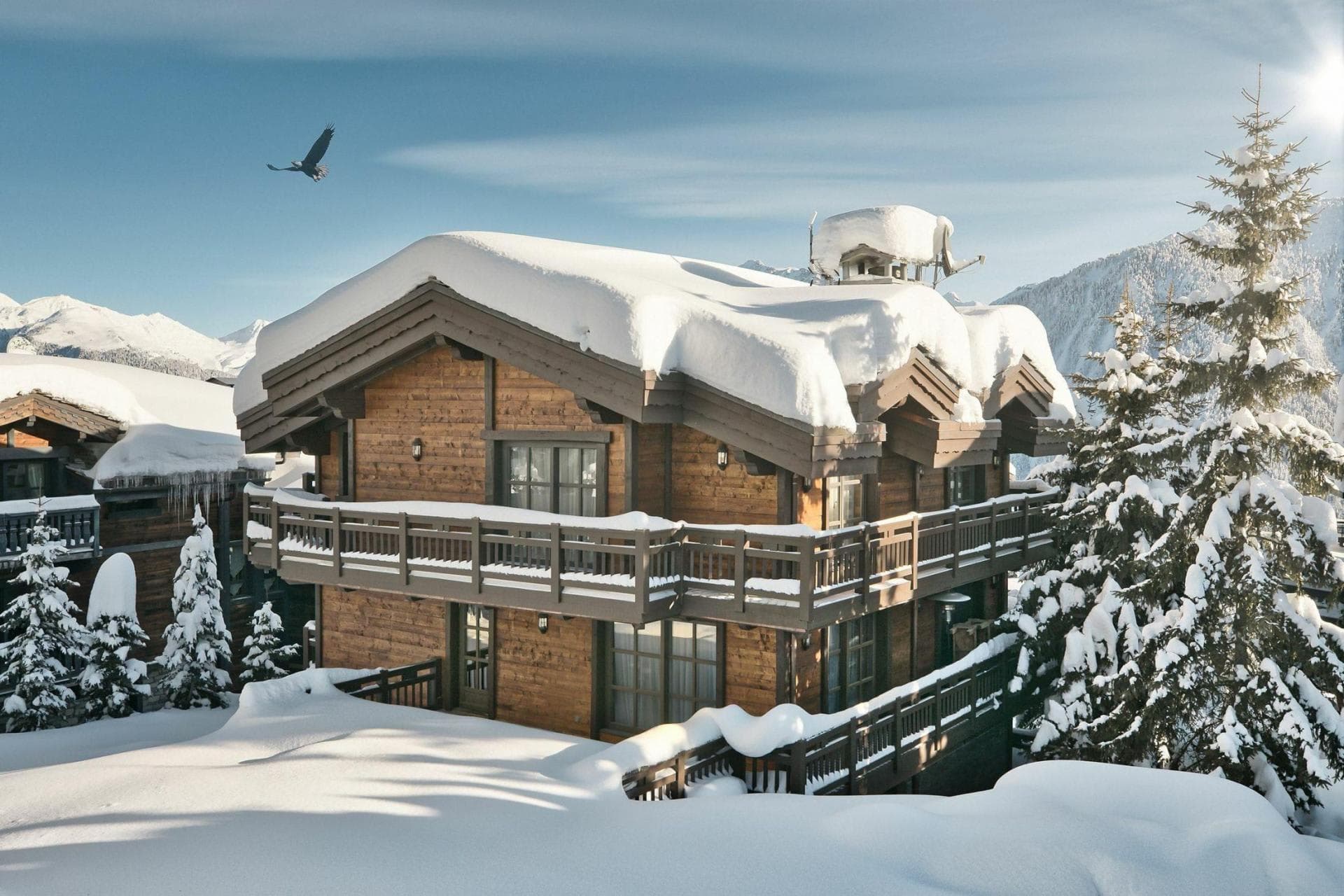Chalet exterior with wrap-around balcony and mountain views