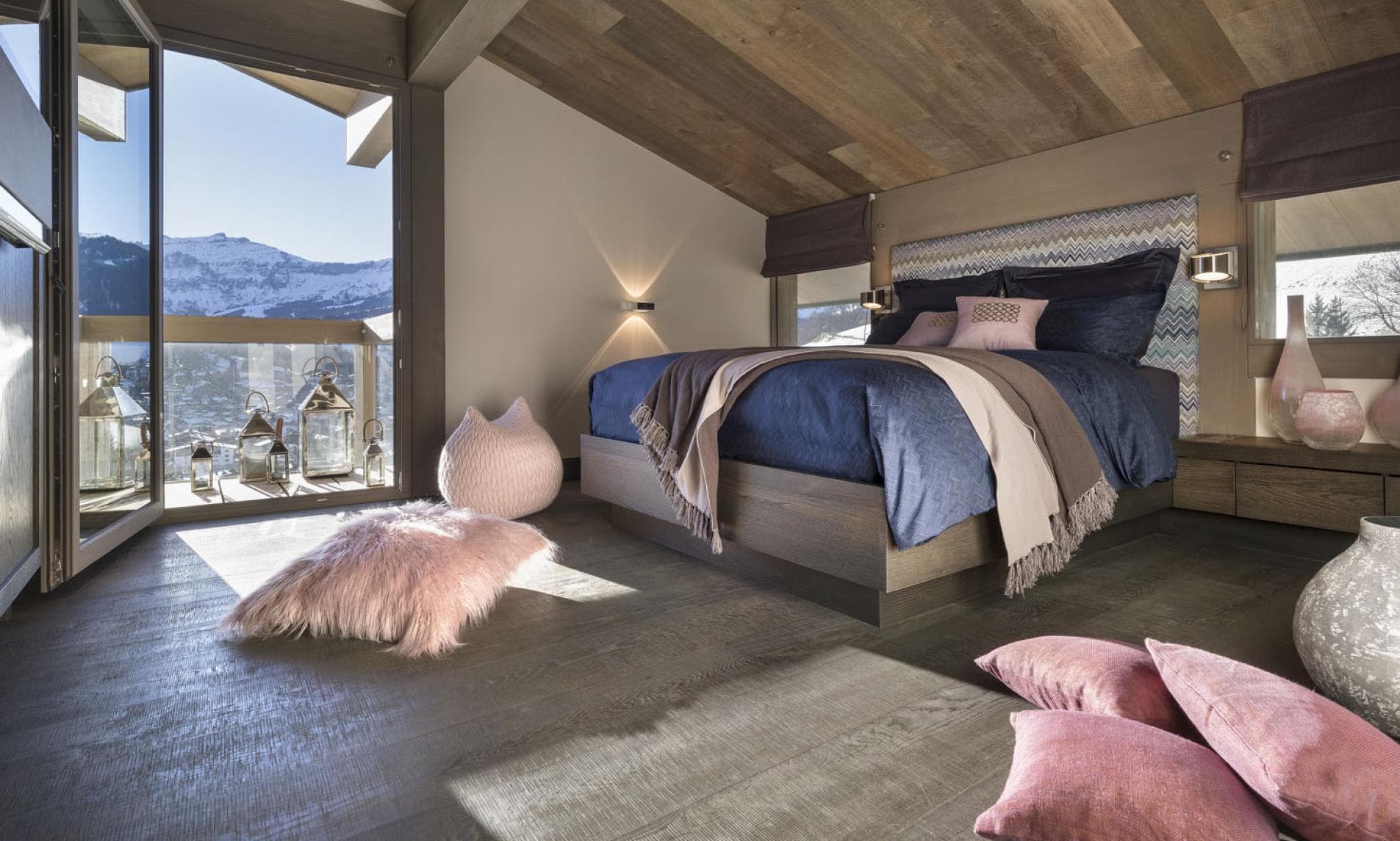 Primary bedroom with king bed and private balcony mountain views