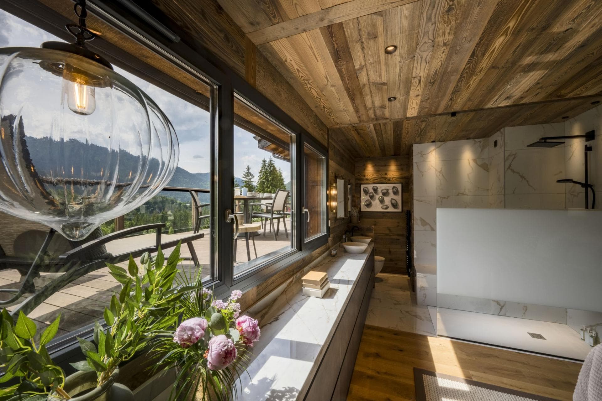 Bathroom with dual vessel sinks, walk-in shower, and mountain view windows