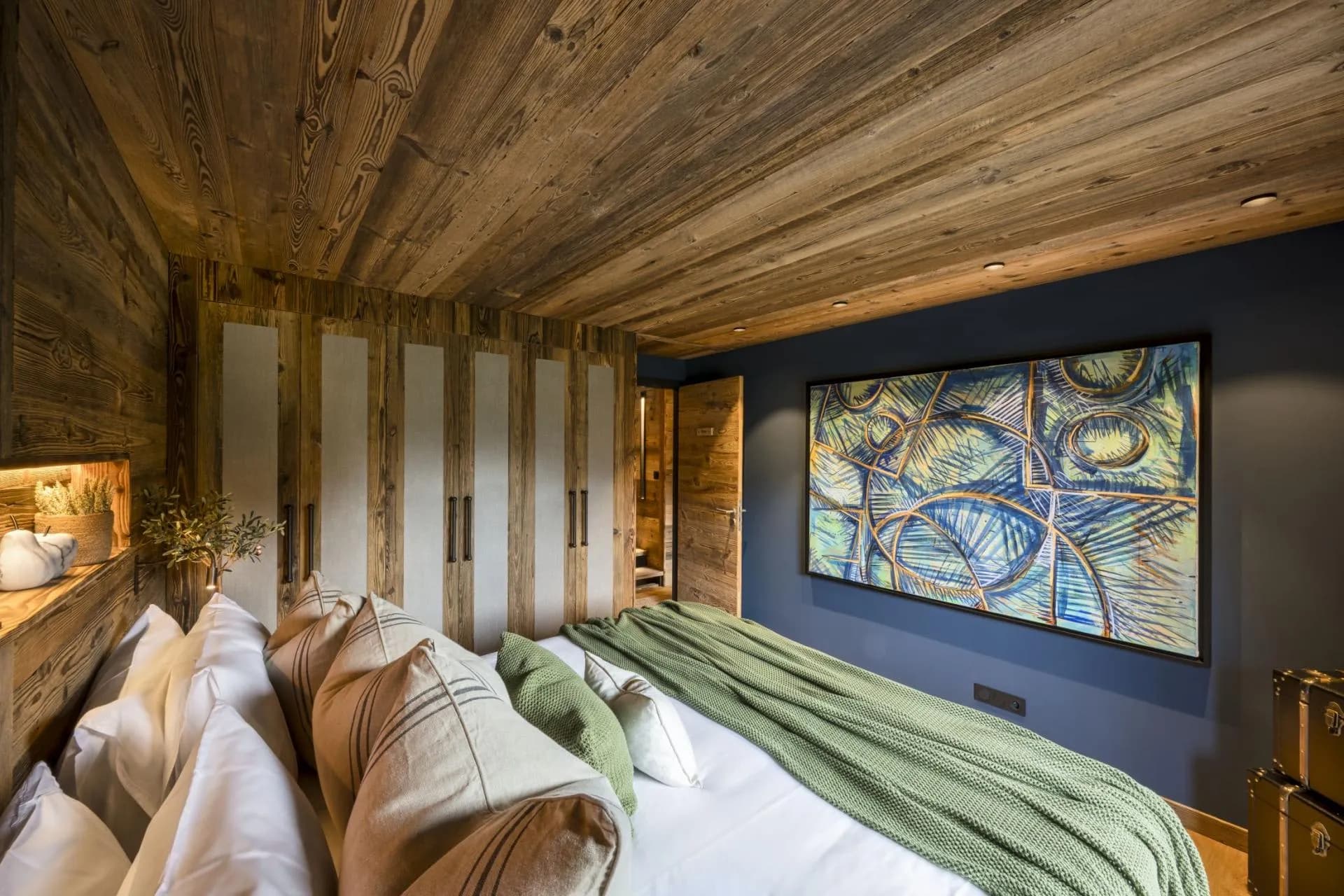 King or twin bedroom with timber walls and built-in storage