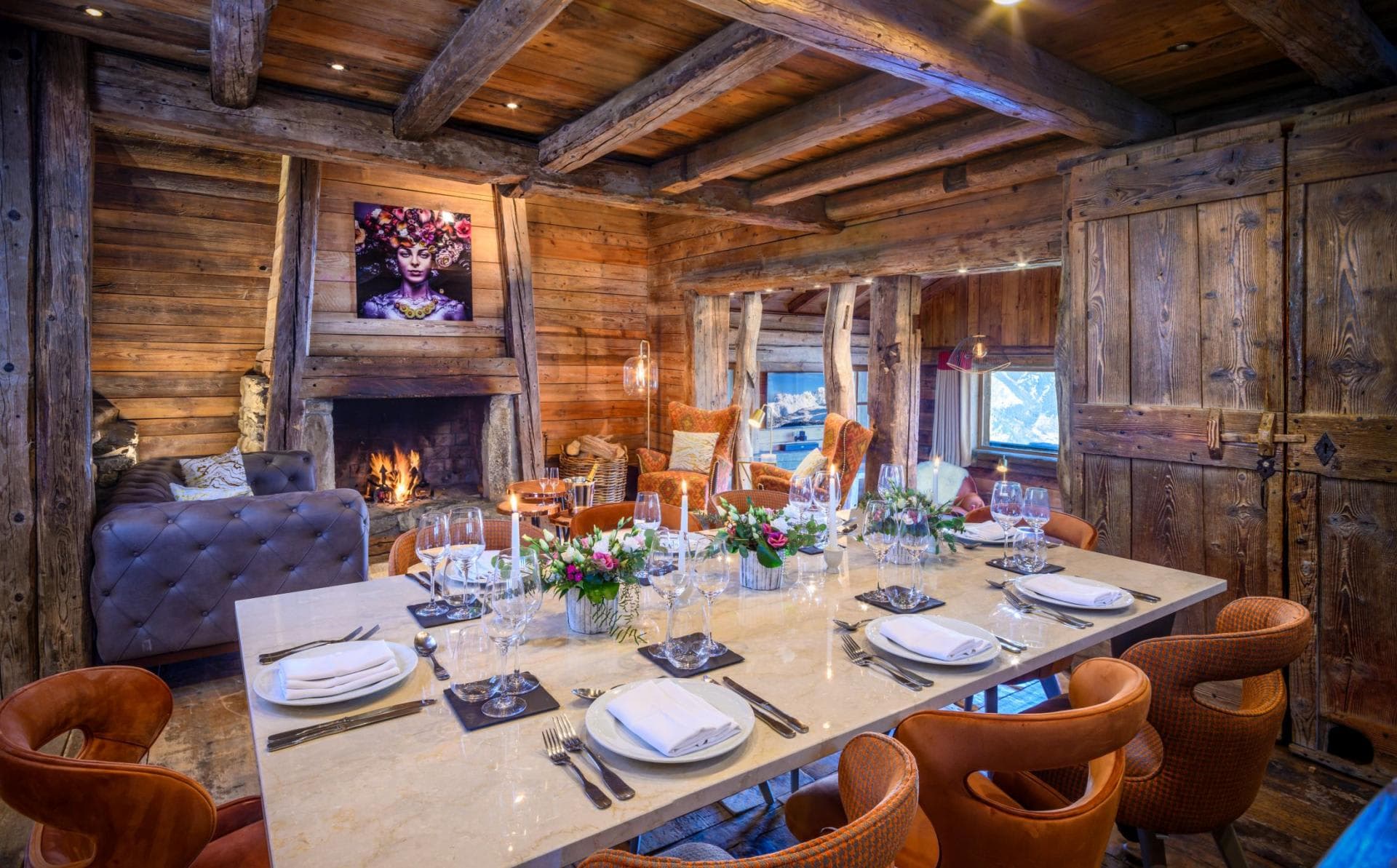 Dining area for 10 with wood-burning fireplace and exposed timber beams