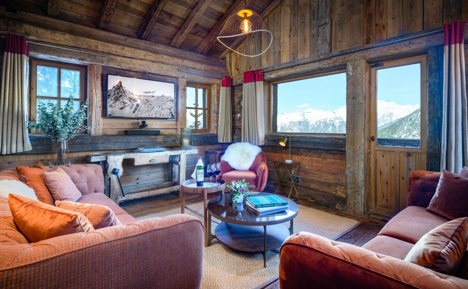 Living area with reclaimed wood walls and alpine peak views