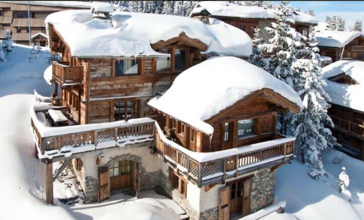 Three-story chalet with stone foundation and private outdoor balconies