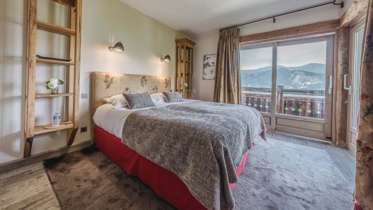 Bedroom with king bed, mountain views, and direct balcony access