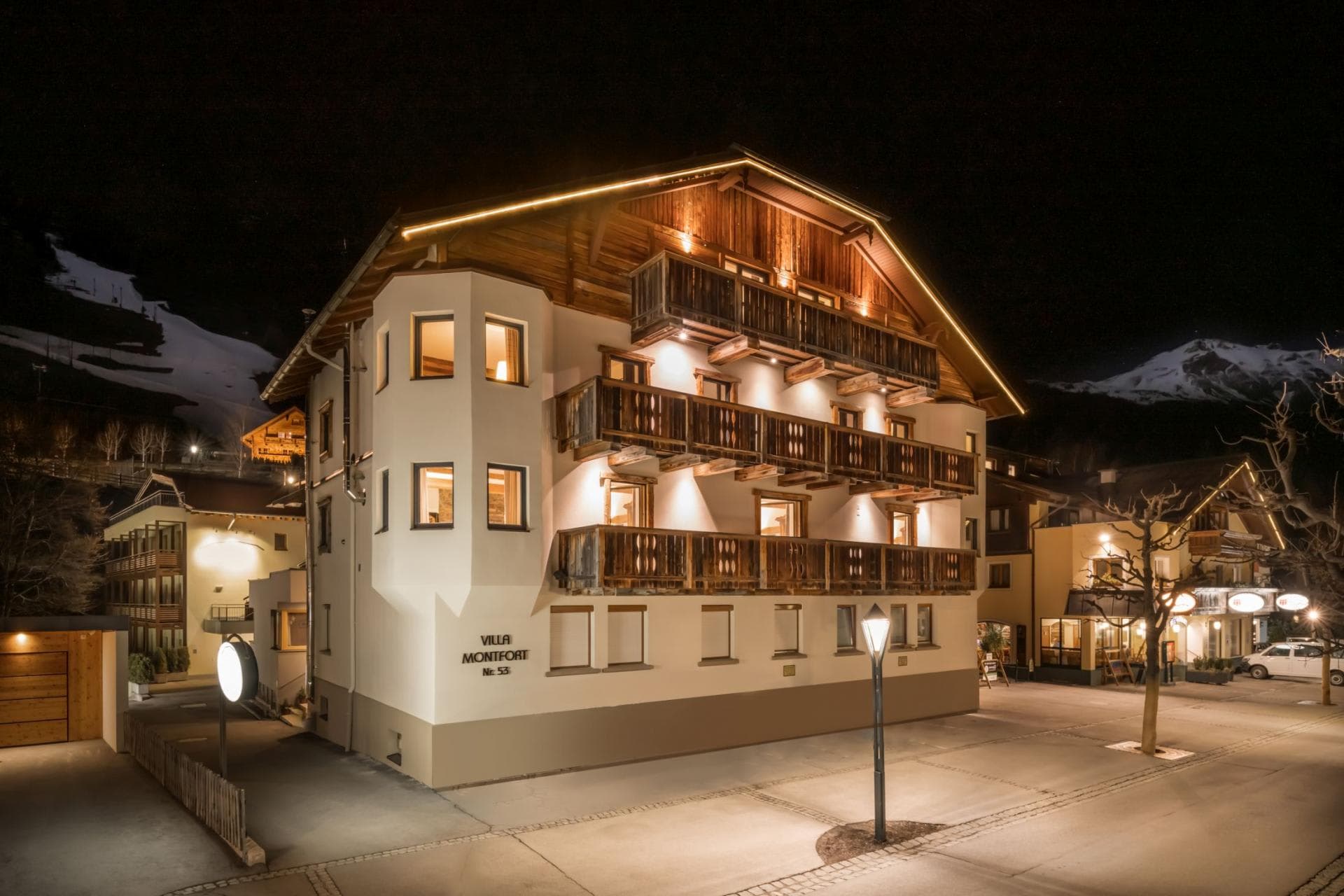 Chalet exterior with multiple balconies and immediate access to town square