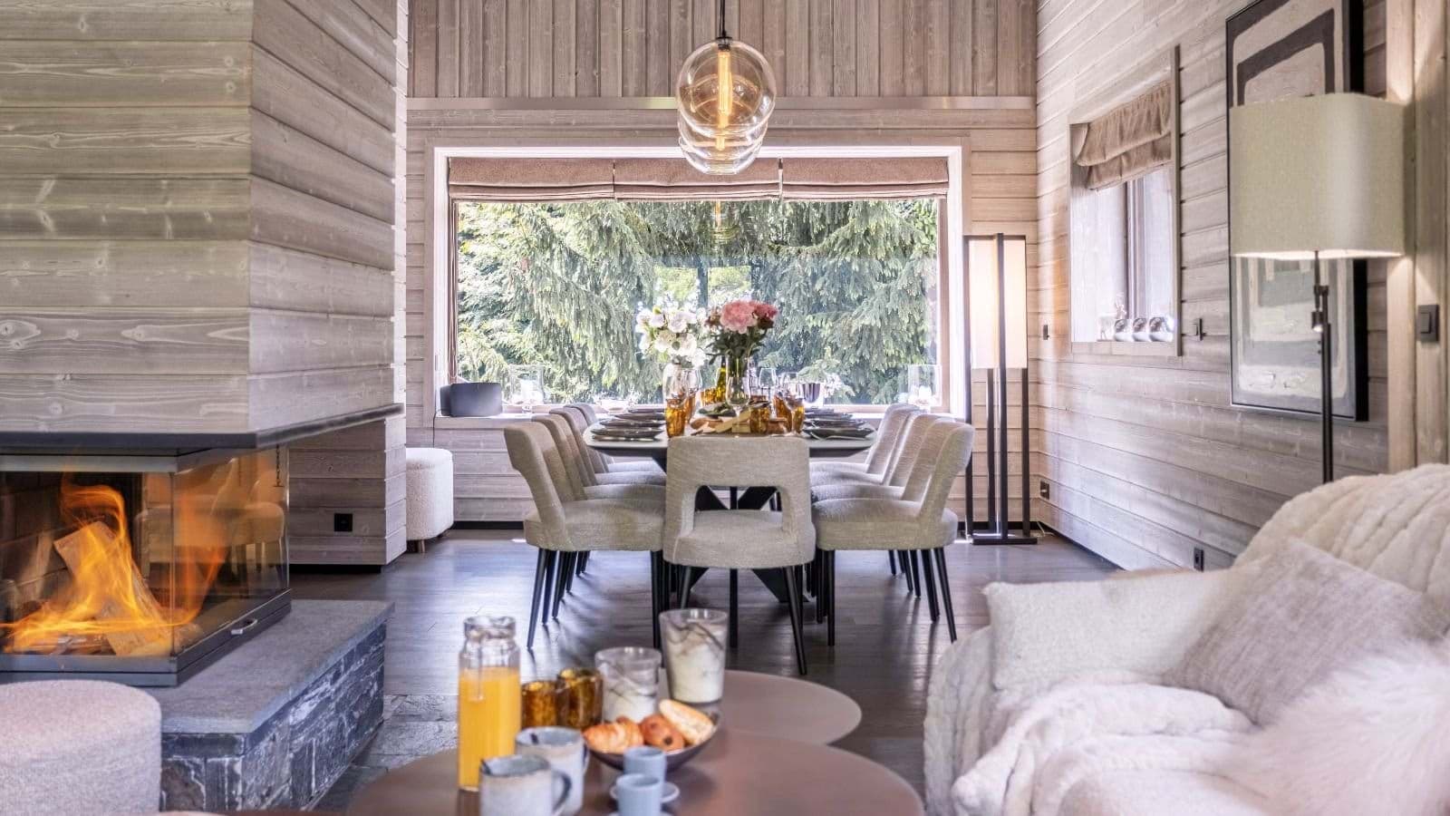 Open-plan dining area seats 10 near wood-burning glass fireplace