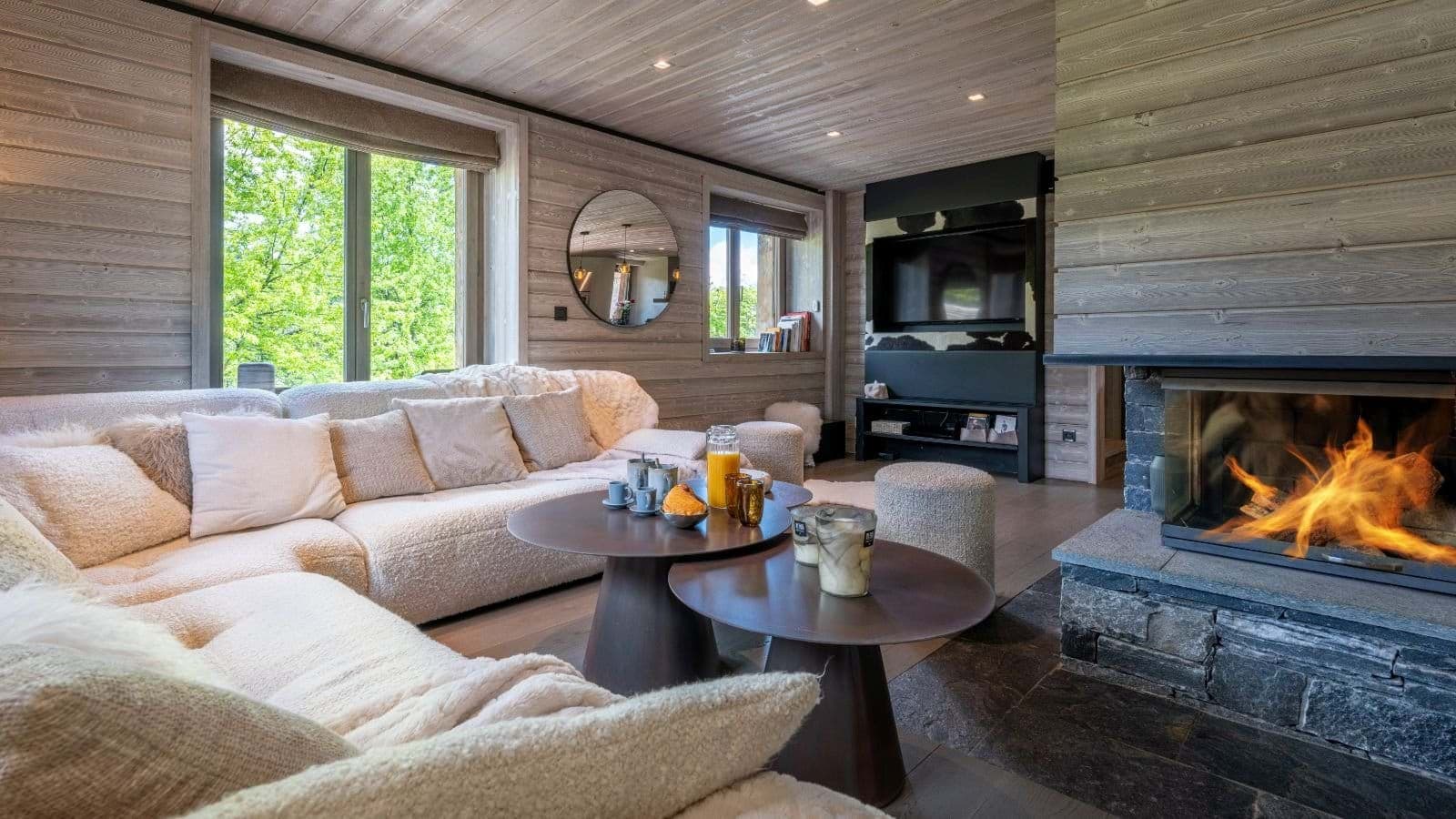 Living area with wood-burning fireplace and wall-mounted Smart TV