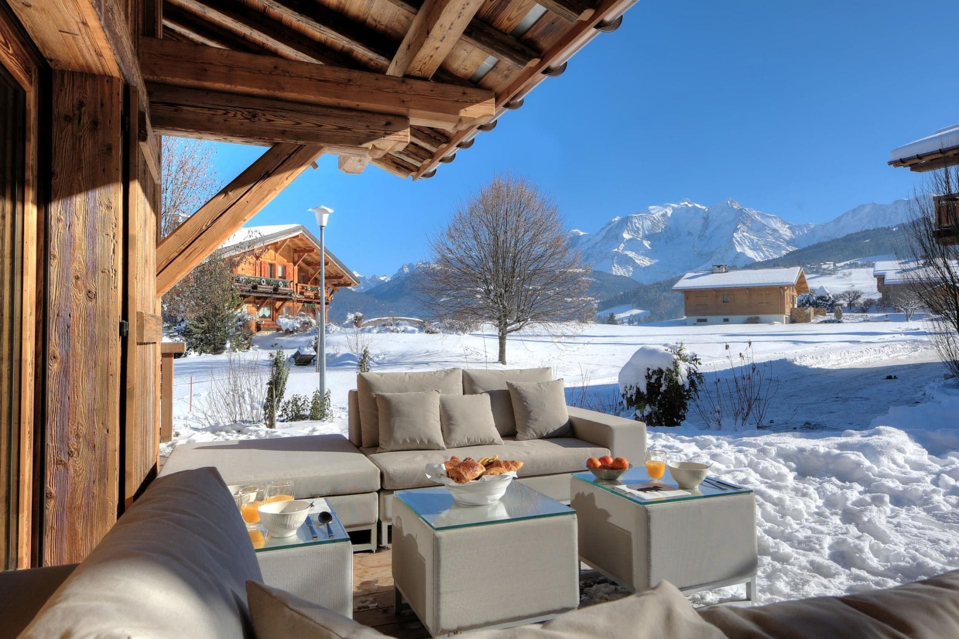 Covered patio with lounge seating and snow-capped mountain views