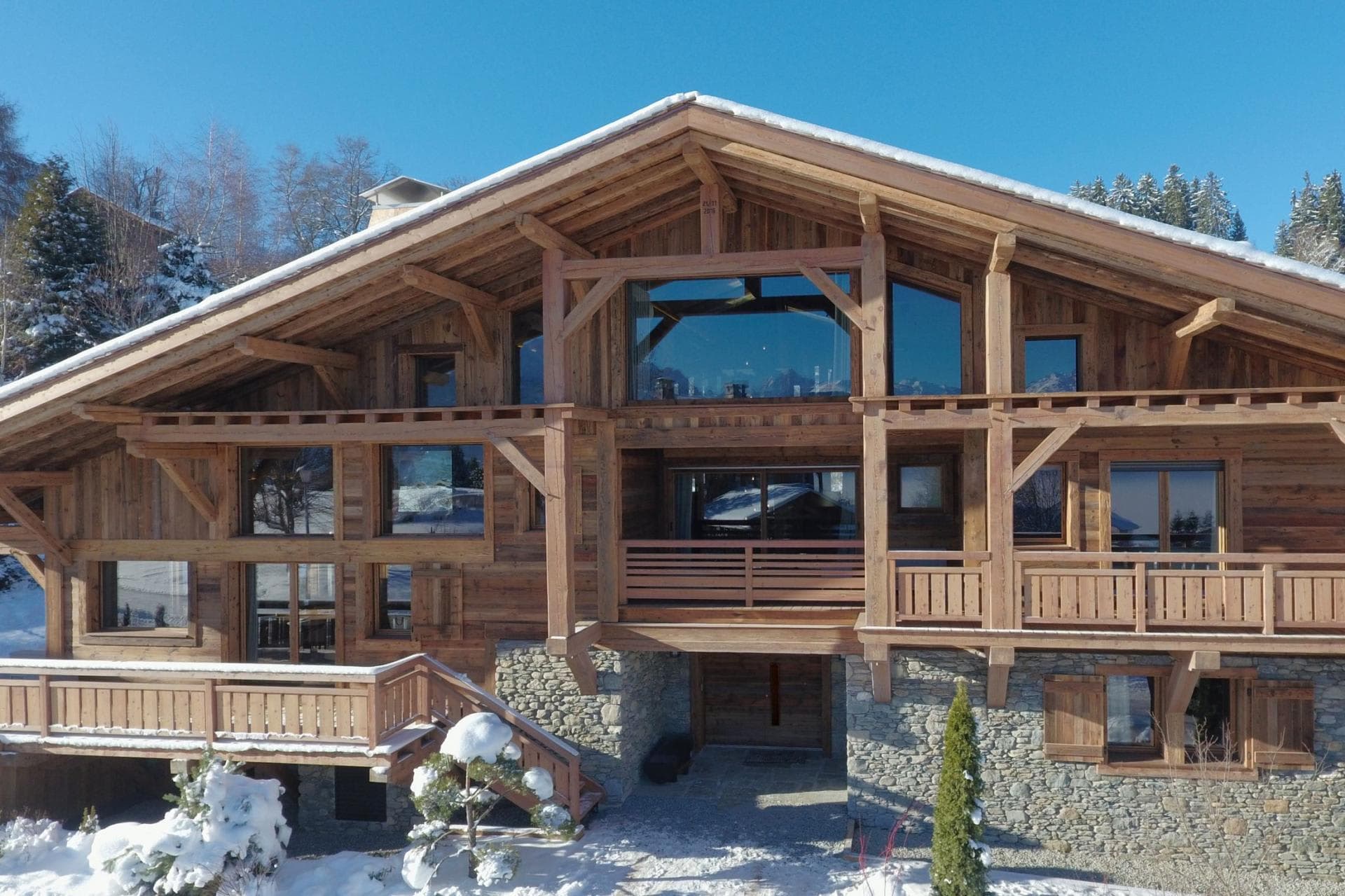 Timber-frame chalet with stone accents and multi-level private balconies
