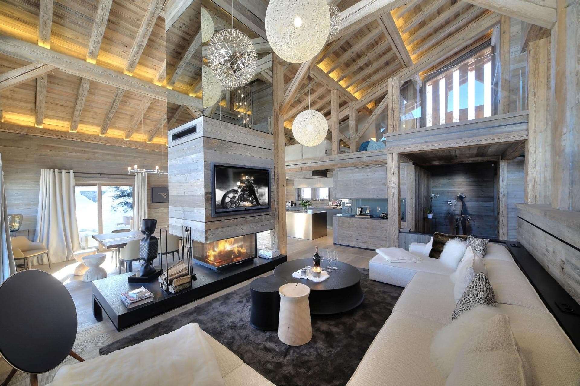 Living room with glass-enclosed fireplace and vaulted timber ceilings