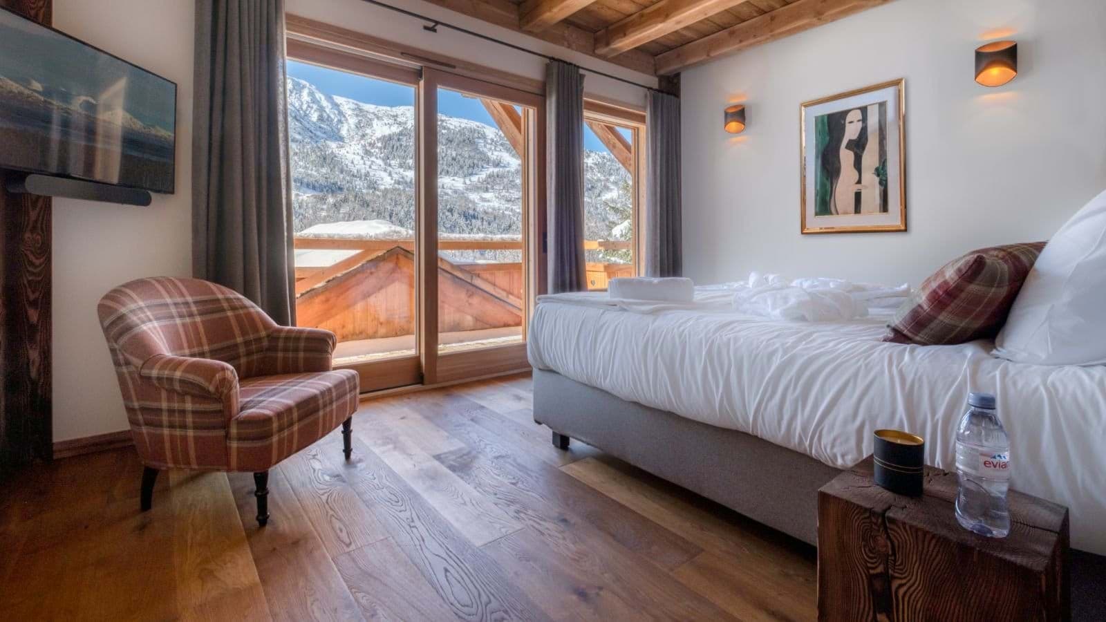 Bedroom with king bed and sliding doors to private mountain-view balcony