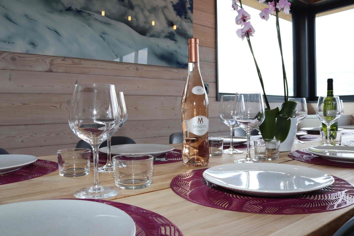 Dining area with large wooden table and mountain-themed artwork