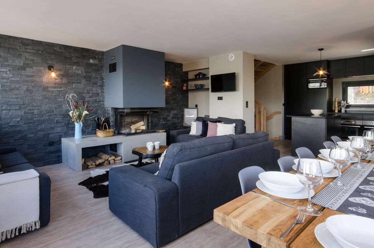 Open-plan living and dining area with wood-burning fireplace