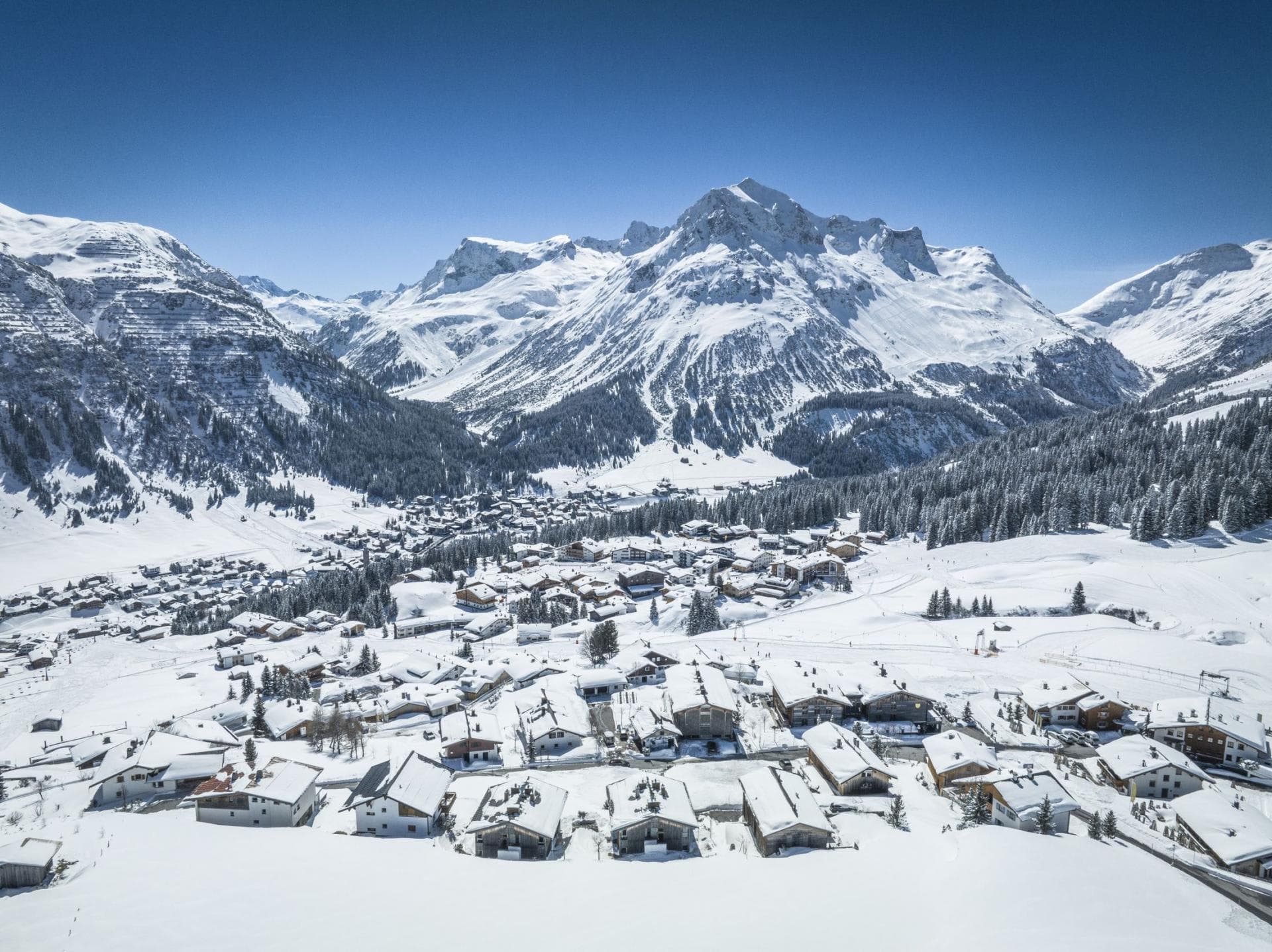Aerial view of snow-covered alpine village with ski-in/ski-out access