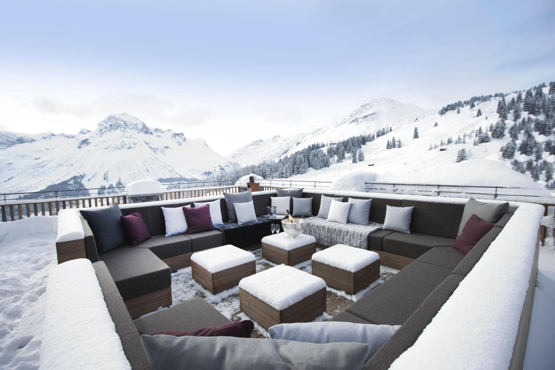 Sun deck with wrap-around lounge seating and panoramic mountain views