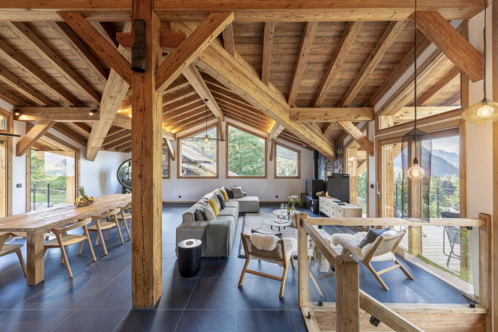 Open-plan living area with vaulted timber beams and seating for 10