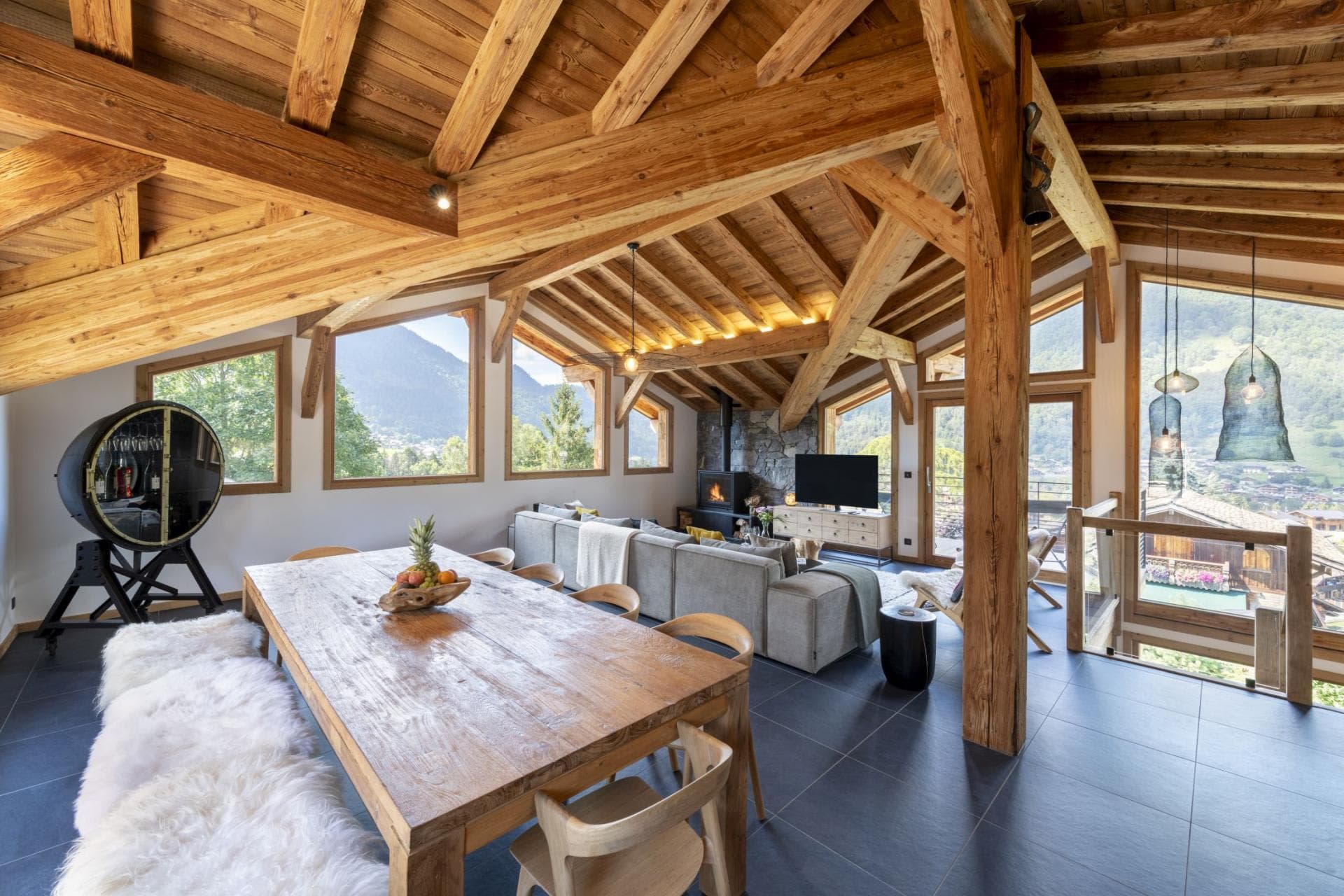 Open-plan living area with wood-burning stove and mountain views