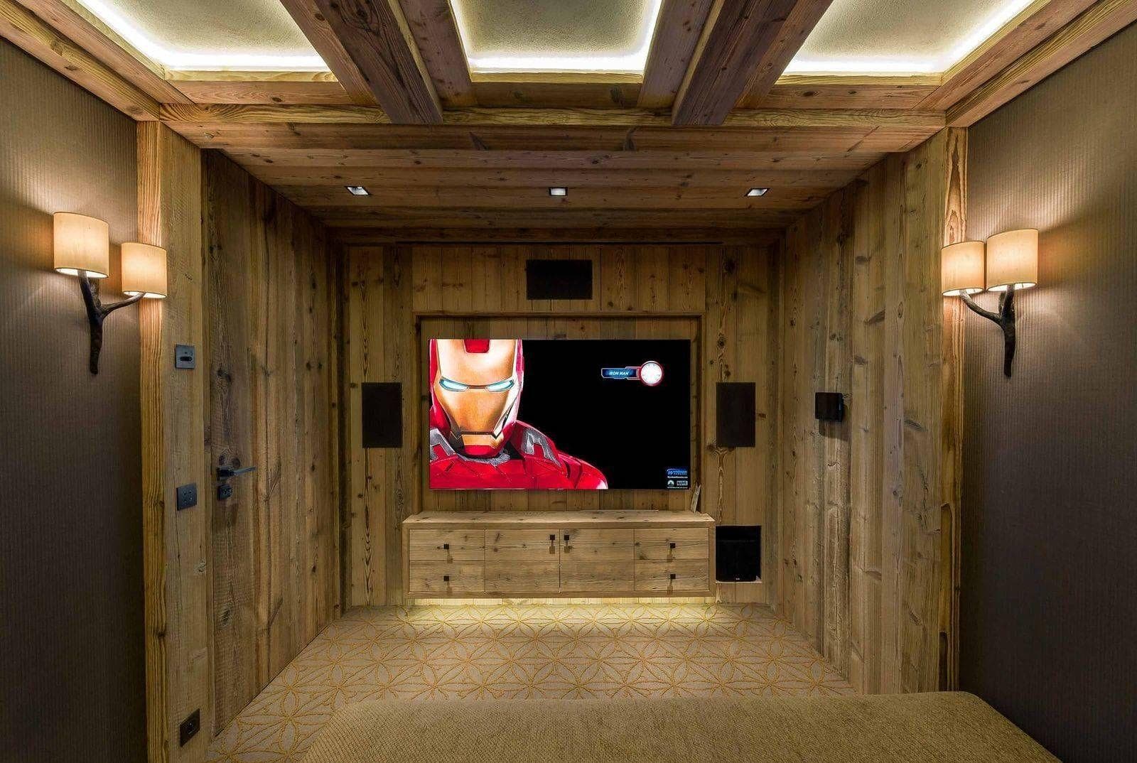 Media room with surround sound and reclaimed wood paneling