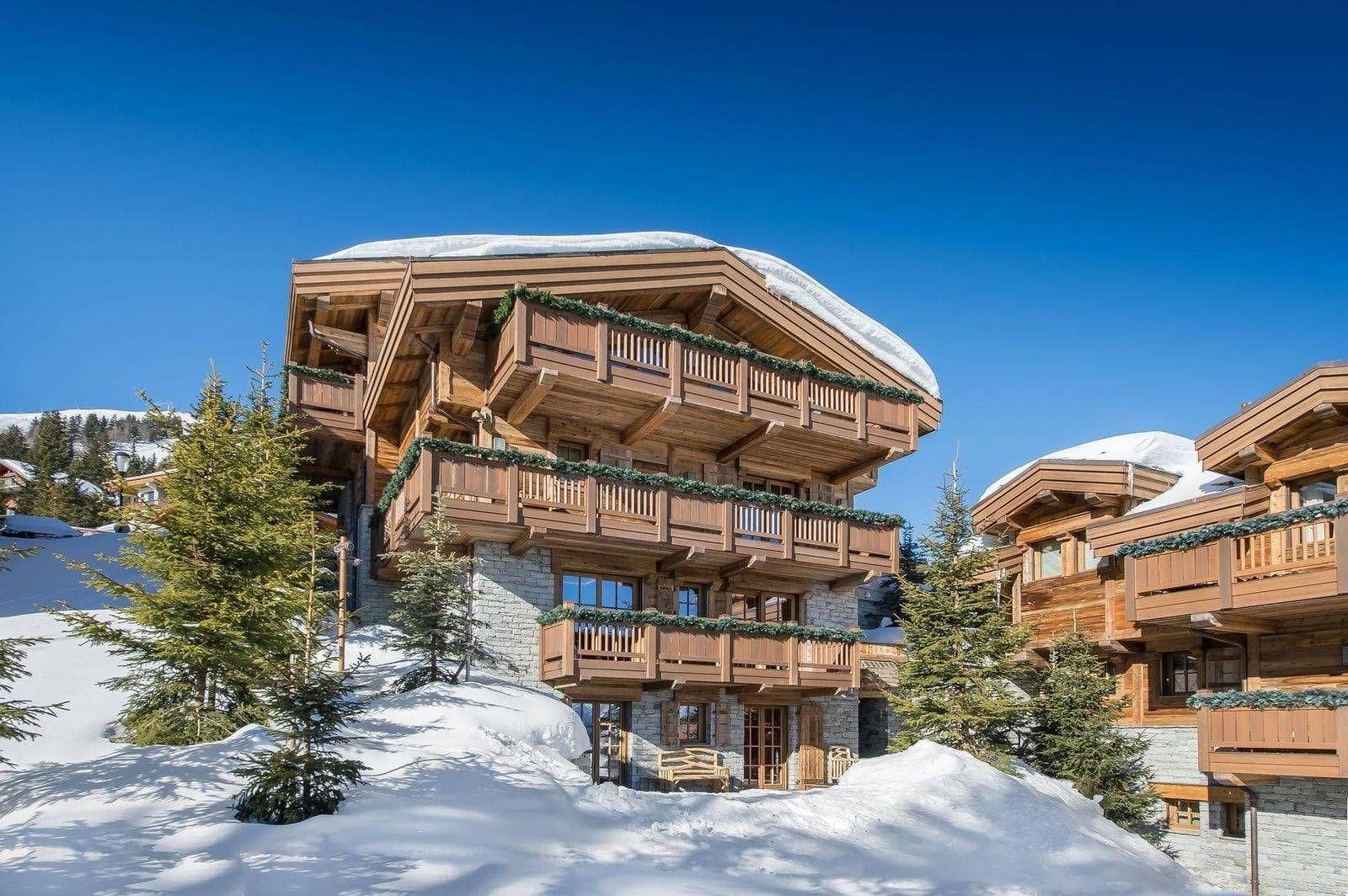 Ski-in chalet with wrap-around timber balconies and snow-front access