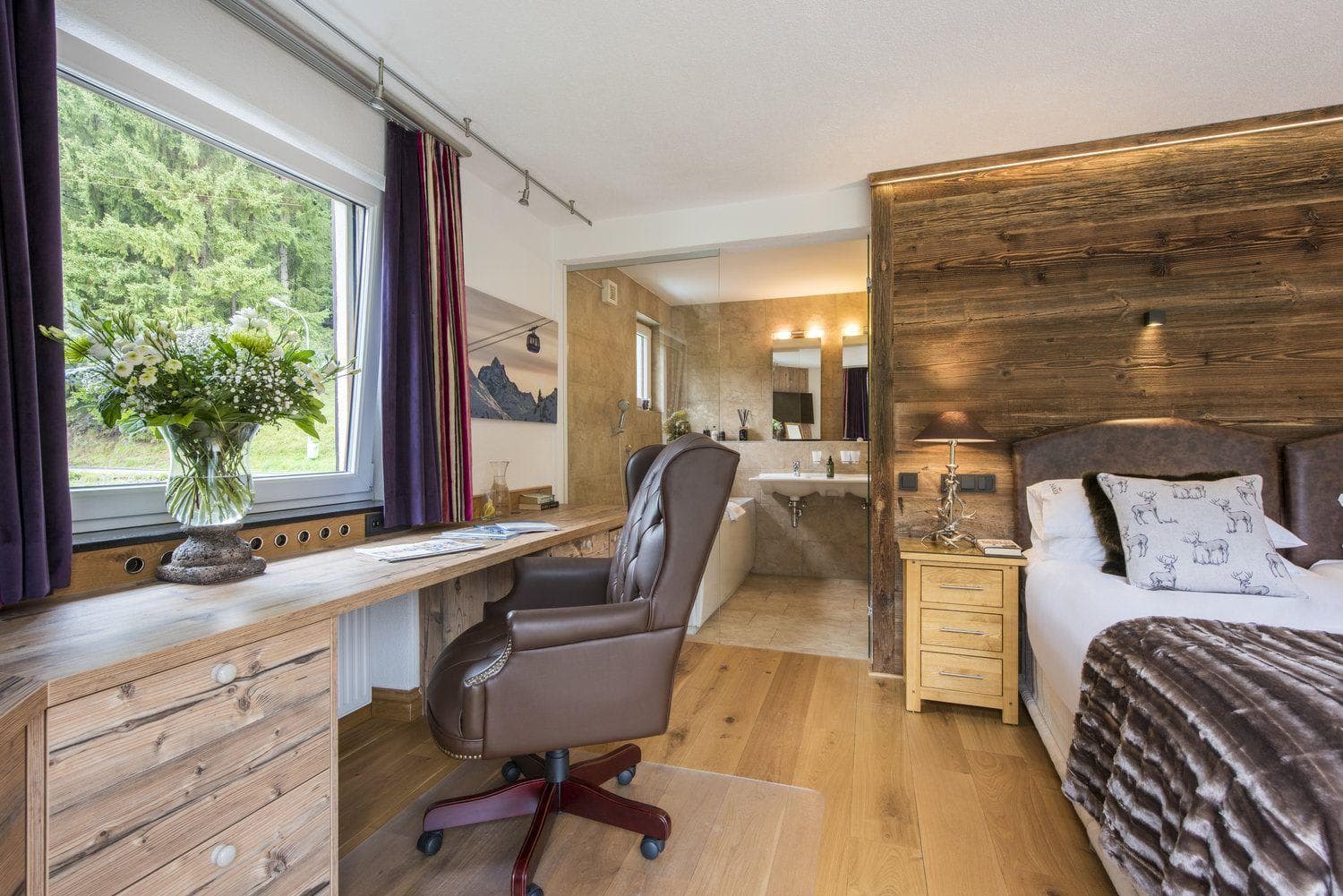 Bedroom with window-side desk and ensuite bathroom