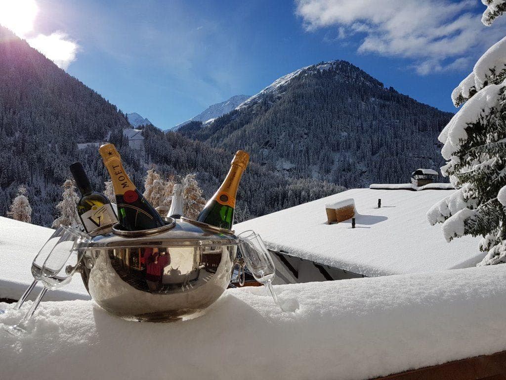 Private balcony with panoramic views of snow-covered mountains and pine forest