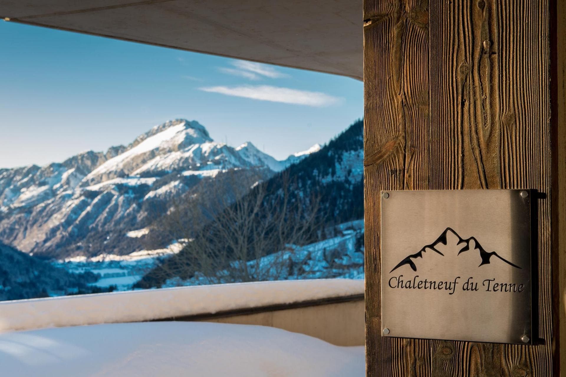 Private terrace view of the snow-capped French Alps and valley