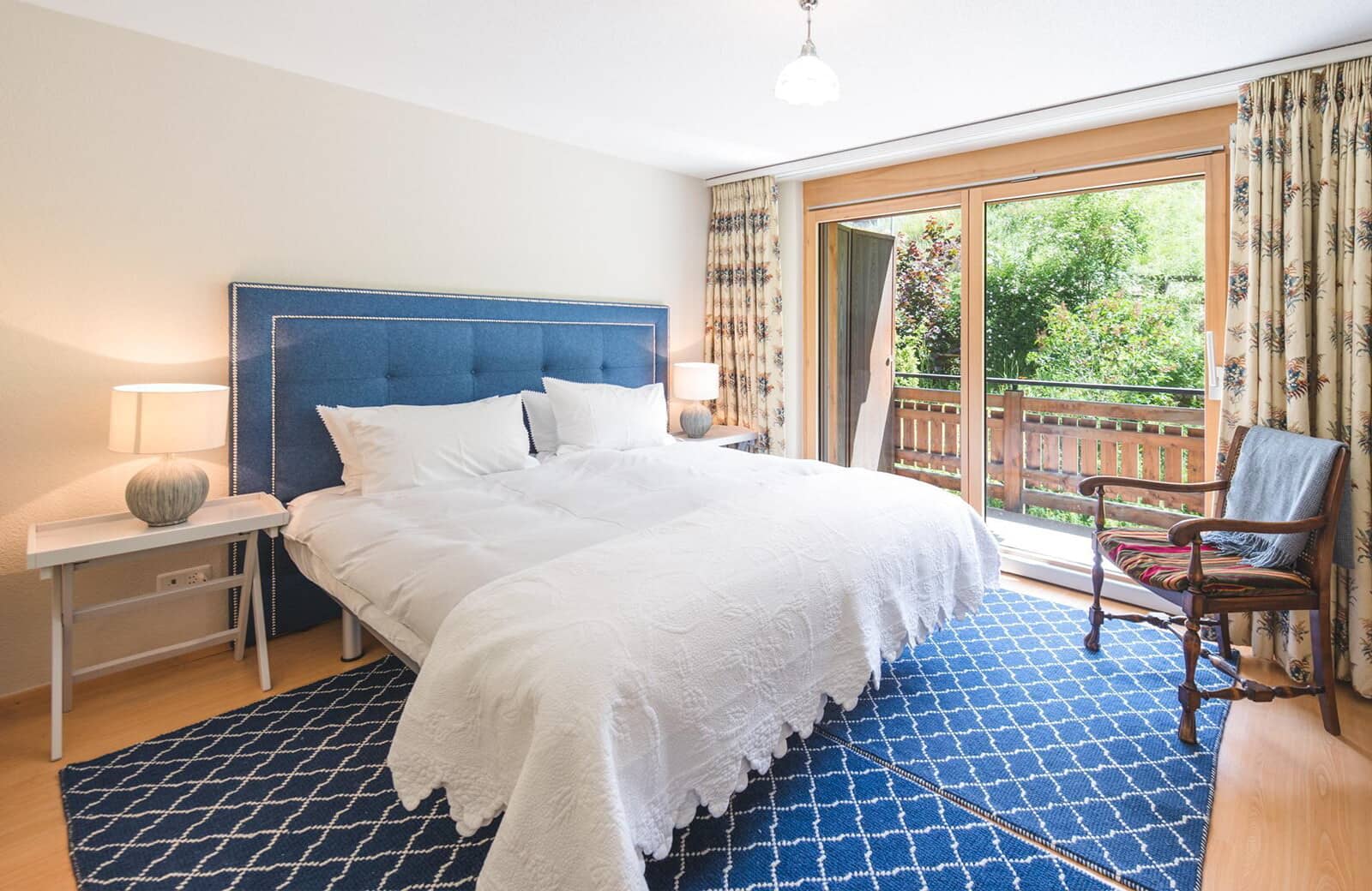 Bedroom with king bed and sliding door access to balcony