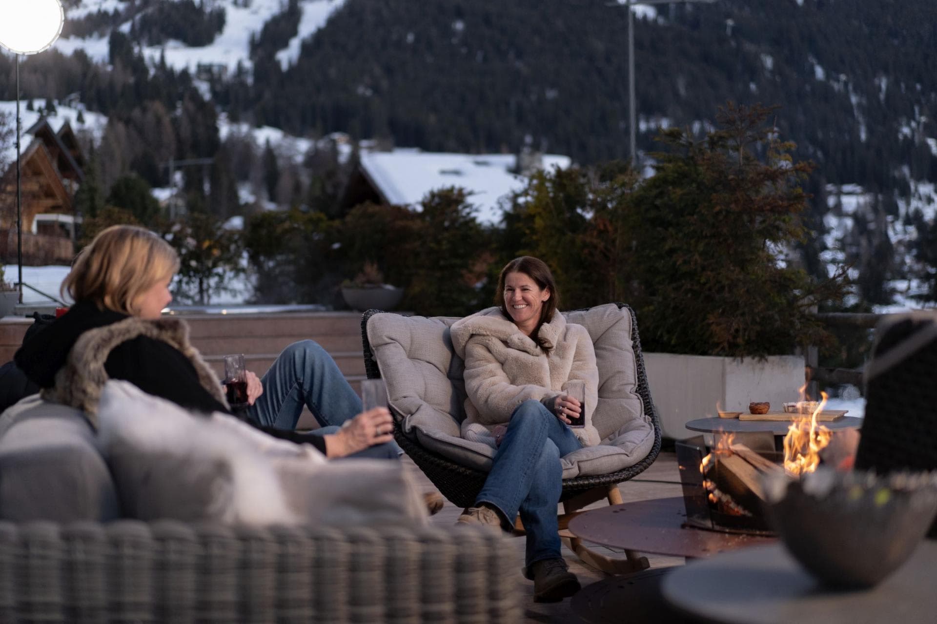 Outdoor terrace with wood-burning fire pit and views of ski slopes
