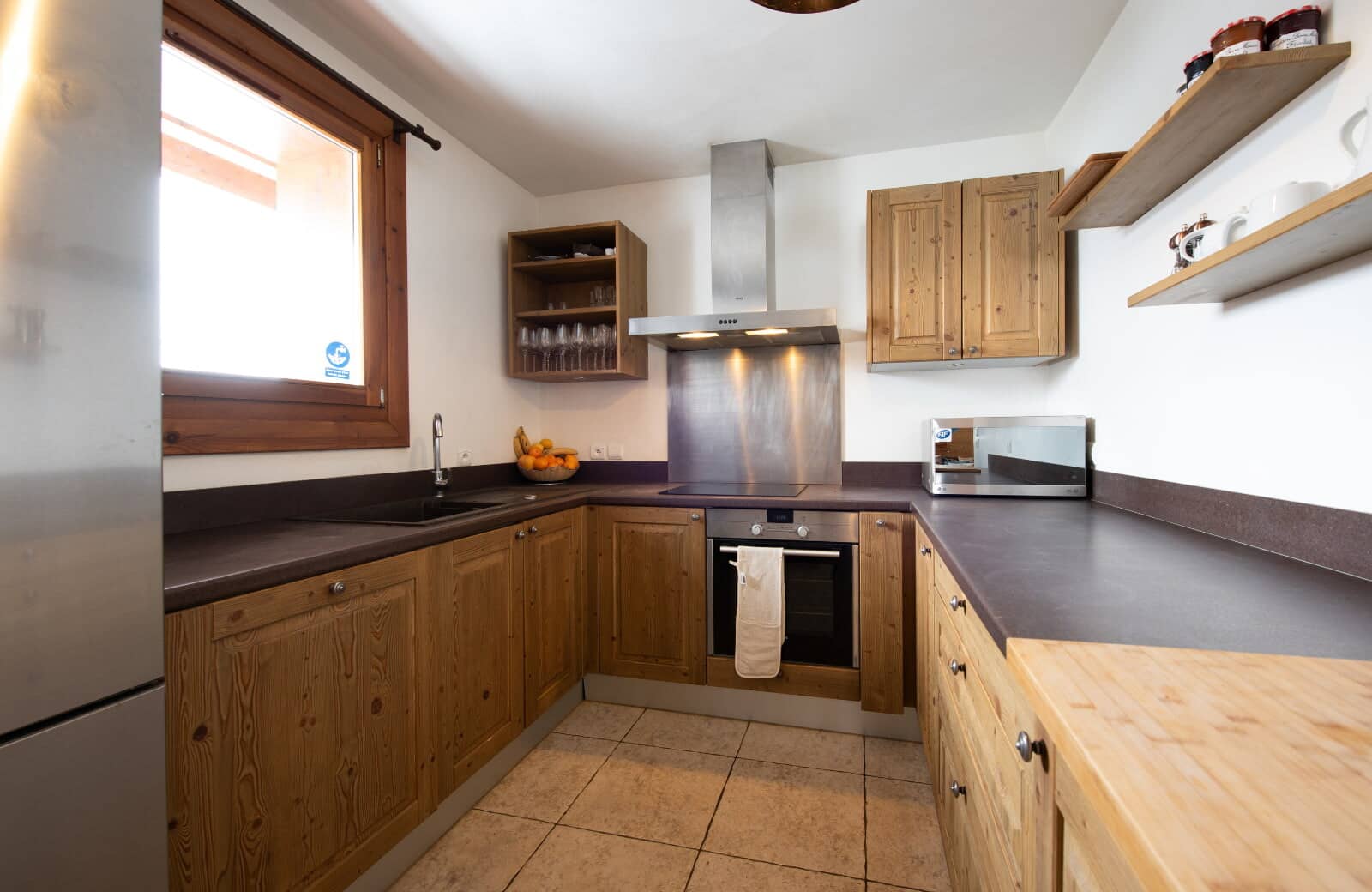 Kitchen with electric cooktop, oven, and microwave